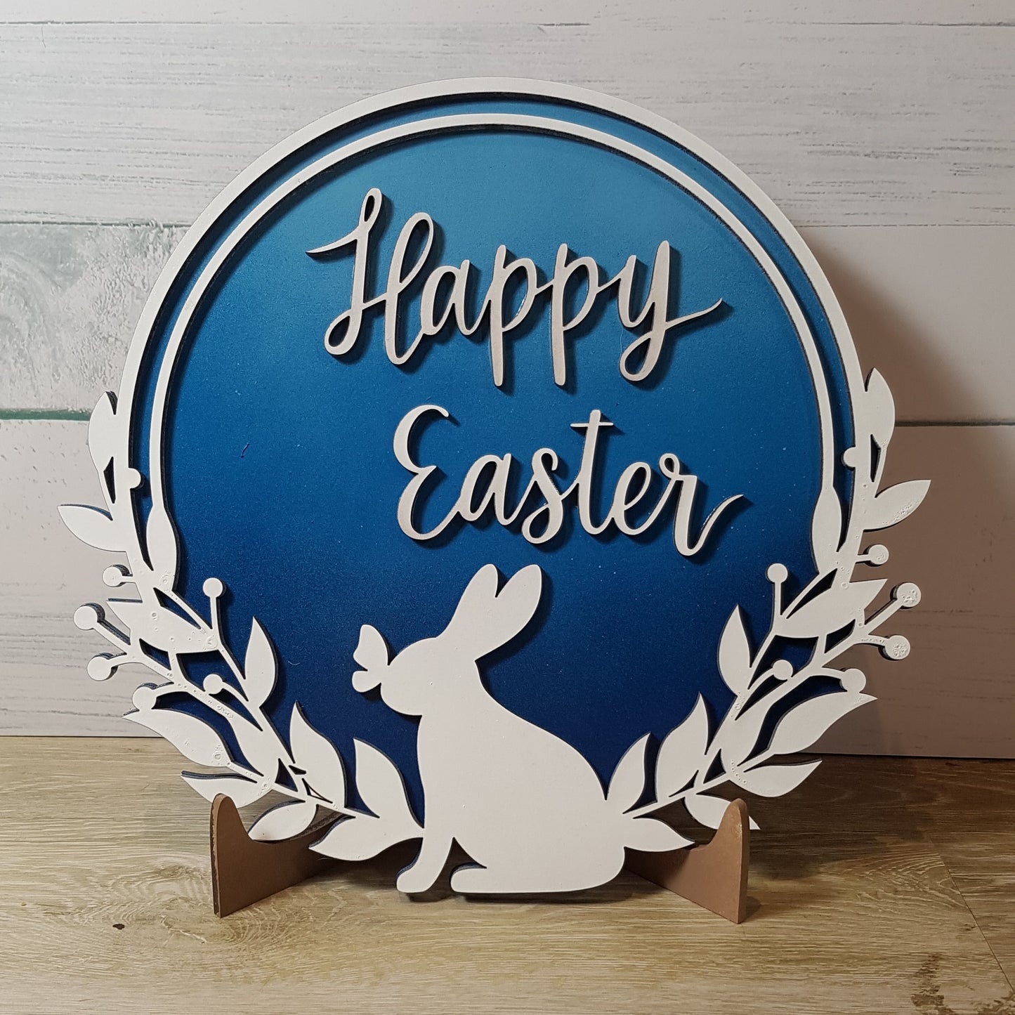 Elevate your Easter decor with our enchanting round Happy Easter sign. Featuring a charming bunny silhouette with a butterfly on its nose and the words "Happy Easter," this 21cm x 21cm round sign is available in five stunning 2-toned ombre effects. Perfect for spreading joy and celebrating the season