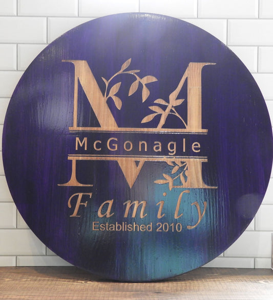 Personalized Laser Engraved Round Family Signs – Crafted Elegance for Timeless Memories. Leafy split monogram with Famiily name and year couple were married. Stained in Deep Purple.