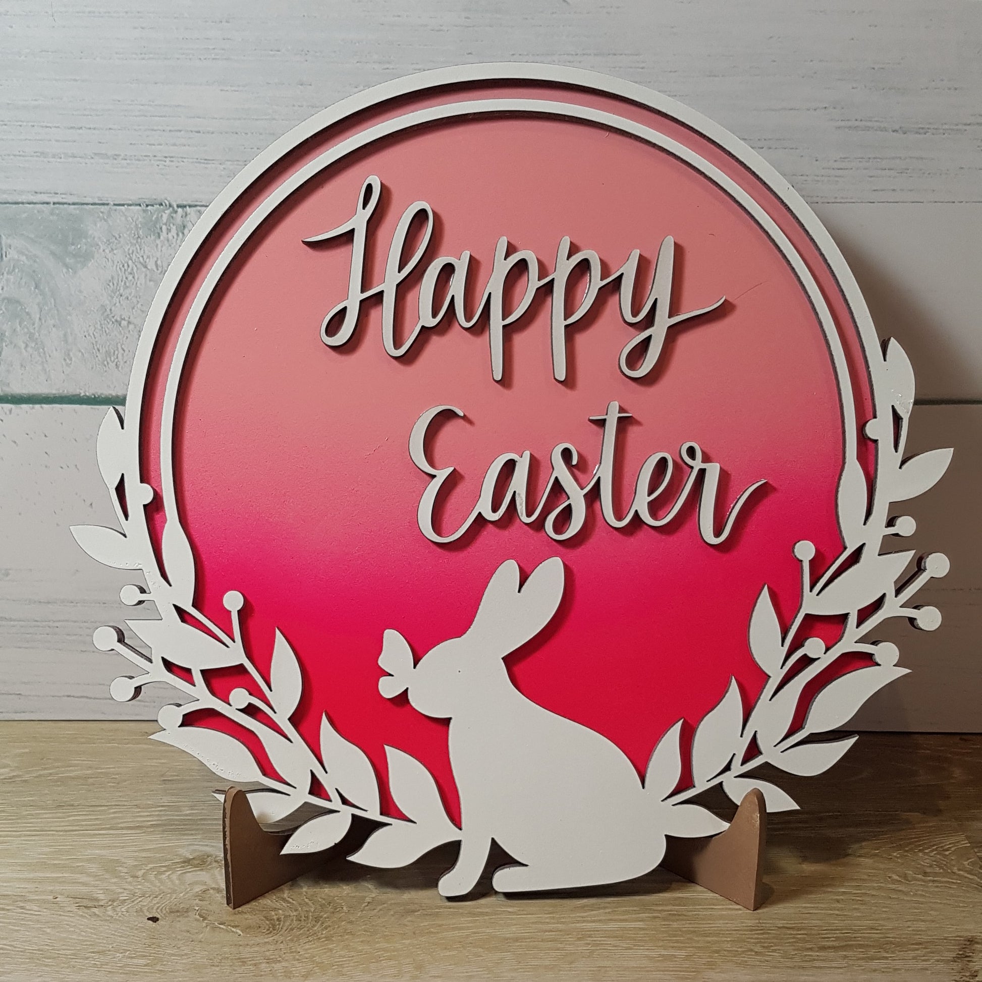 Elevate your Easter decor with our enchanting round Happy Easter sign. Featuring a charming bunny silhouette with a butterfly on its nose and the words "Happy Easter," this 21cm x 21cm round sign is available in five stunning 2-toned ombre effects. Perfect for spreading joy and celebrating the season