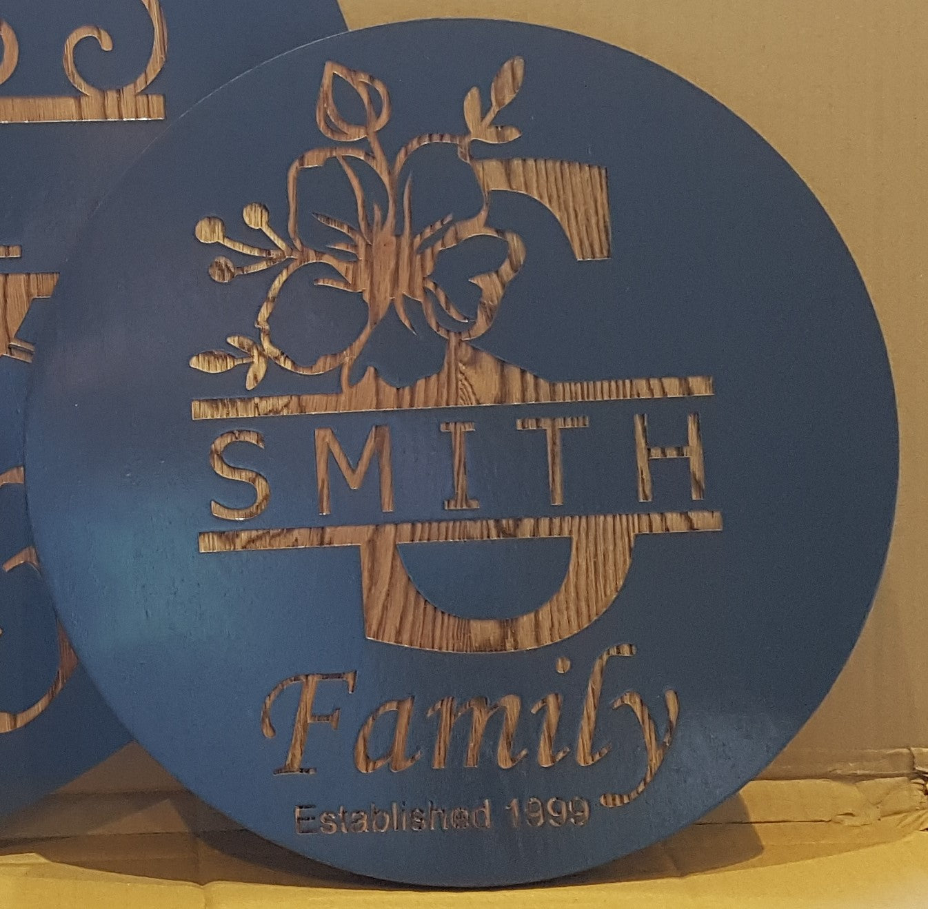 Personalized Laser Engraved Round Family Signs – Crafted Elegance for Timeless Memories. Peony split monogram with Famiily name and year couple were married. Stained in  Skywater Blue.