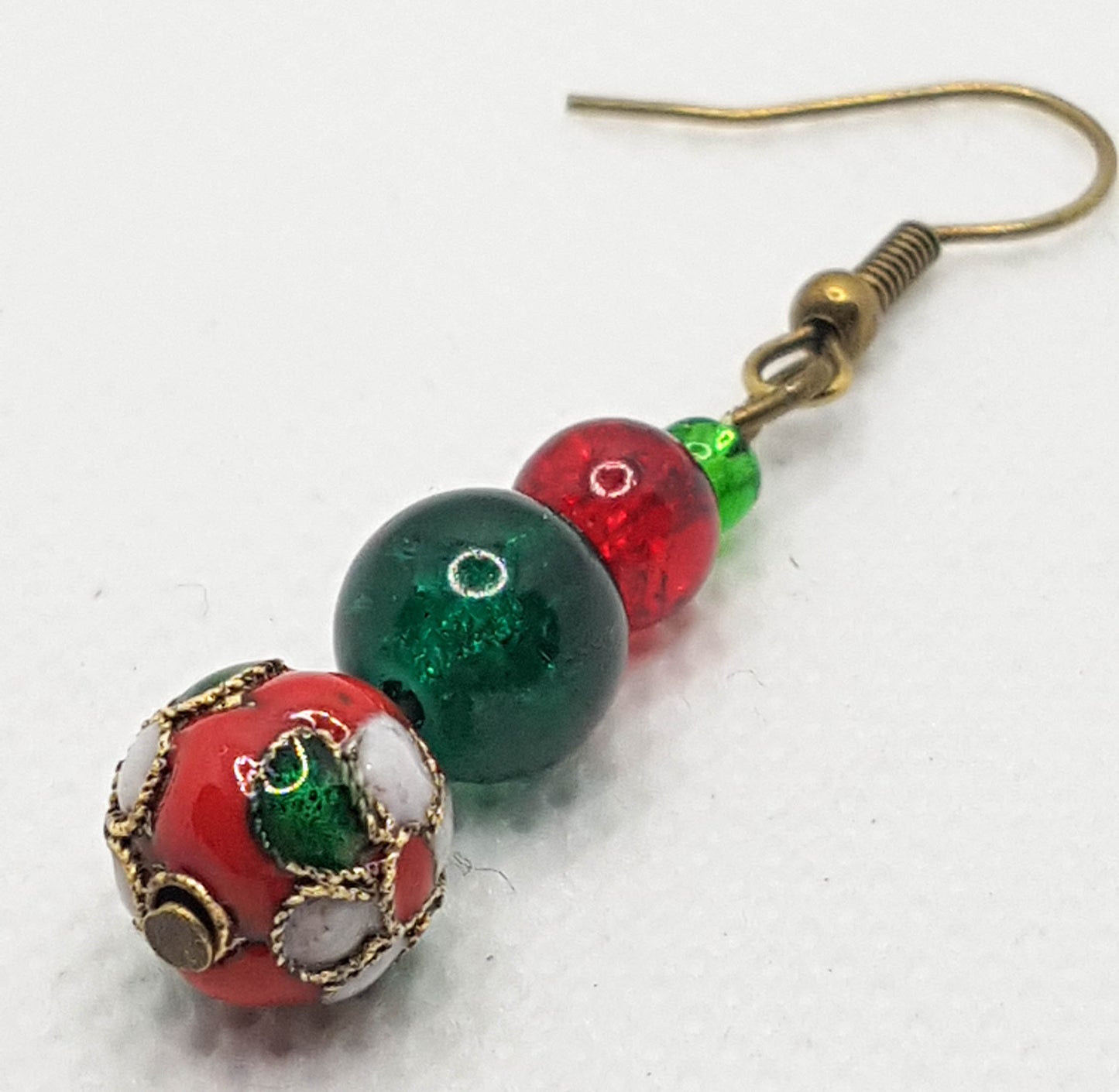 Red cloisonne focal bead,  a decorative red glass crackle bead and topped with red & green seed beads on Antique brass findings